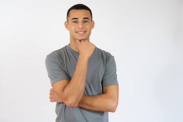 Fototapeta na wymiar Attractive young man in casual t-shirt with arms folded isolated over white background.