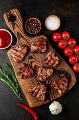 several mini Grilled beef T-bone steaks on stone background