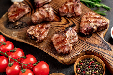 several mini Grilled beef T-bone steaks on stone background