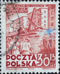 POLAND-CIRCA 1951 : A post stamp printed in Poland showing construction work with excavators in front of houses. Six Years Plan - House Building