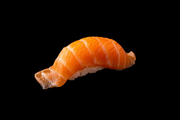 Salmon Sushi isolated on black background, Rice ball on top with Salmon sliced.