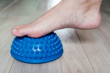 Fototapeta premium Foot steps on the trigger point massage ball to relieve Plantar fasciitis or heel pain