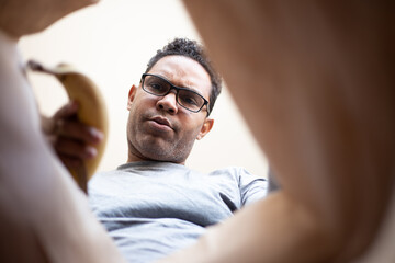 latin man opening box at home due to pandemic