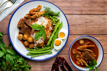 Rice noodles with fish curry sauce, top with meatball, chicken blood cubes, chicken feet, boiled egg and many vegetable. Thai food, Thai call it 