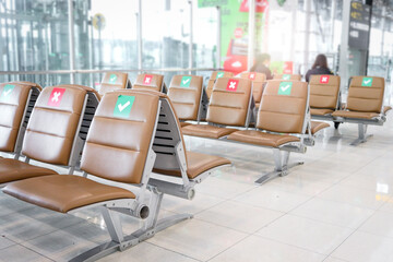 Row of empty chairs seat showing cross sign on red and check mark on green for social distancing idea. Avoid tourists and passengers keep sitting distance away from each other to prevent coronavirus (