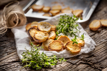 Obraz na płótnie Canvas Crispy goldish bake rolls with savory flavour, served with lovely green thyme tied by flax twine