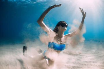 Female freediver underwater. Freediving in transparent sea