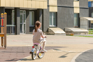 Little girl rides her bike on a walk