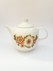 Mid-century modern porcelain teapot with flower pattern isolated
