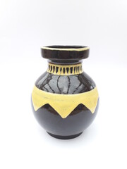 Mid-century modern black ceramic vase with yellow geometric pattern isolated