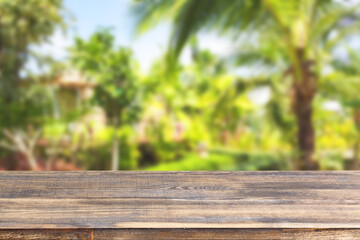 wood table top on blur tropical plants background