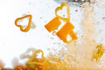 Subjective view of pasta hearts boiling in a saucepan