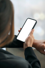 Closeup view of caucasian woman hand holding blank screen smartphone.