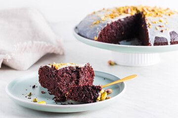 Homemade brownie cake with pistachios in icing.