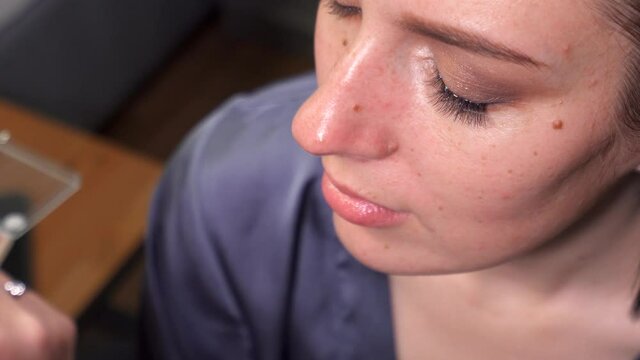 makeup close-up. gluing false eyelashes in bundles