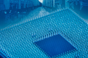 Close-up of a part of a microprocessor in soft focus under high magnification. Details of a computer component under a microscope in tech blue light.