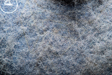Thick layer of dust on the plastic surface. Background in soft focus at high magnification