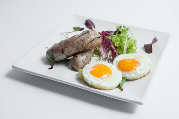 tasty and fresh fried scrambled eggs with sausages