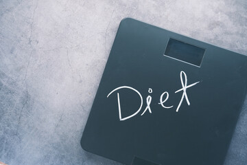 diet text on weight scale on wooden table, top view 