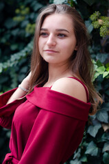 beautiful girl in a red dress on the street in the city