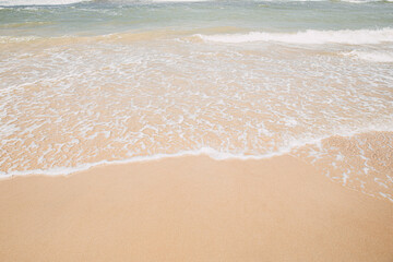 Soft wave on the sandy beach, summer background.