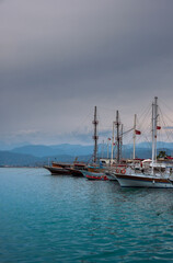 Fototapeta na wymiar Yachts in the port of Fethiye, Turkey in the evening against the backdrop of mountains