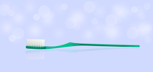 turquoise plastic toothbrush on blue background