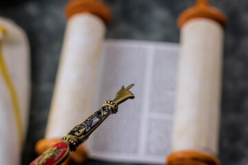 Jewish synagogue Judaic religion of Torah Scrolls with the pointer for reading the Torah