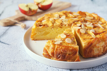 French cuisine. Invisible apple tart, almond petals dressing