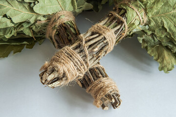 The oak branches of the bath broom, wrapped with twine, are close-up