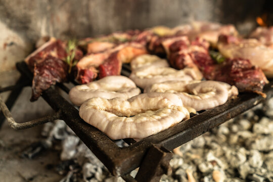 Close-up of Argentine style grilled chinchulines. Concept of barbecue with "achuras".