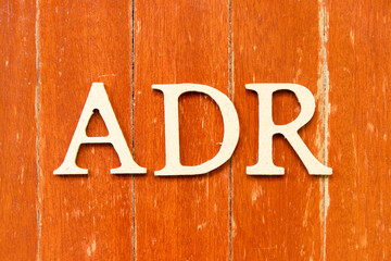 Alphabet letter in word ADR (Abbreviation of adverse drug reaction) on old red color wood plate...