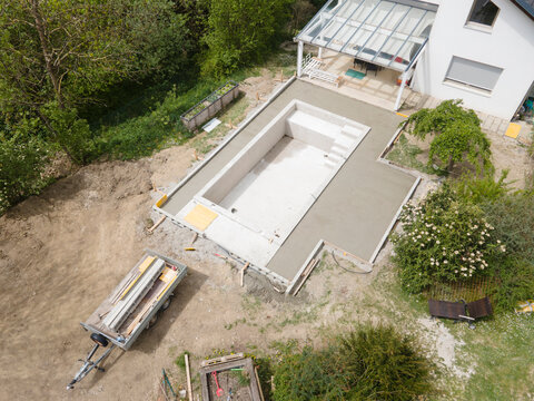 aerial drone flight pic of Swimming pool construction site from above in a garden in austria