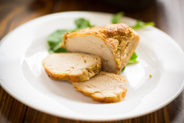 baked chicken fillet pieces with spices and herbs, in a ceramic form