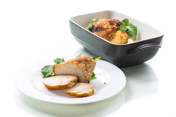 baked chicken fillet pieces with spices and herbs, in a ceramic form