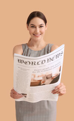 Young businesswoman reading newspaper on color background