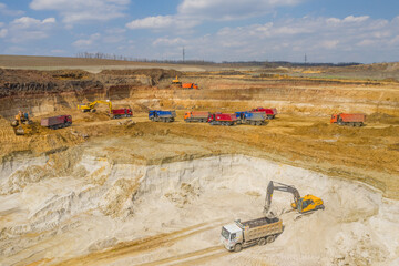 Quarry, mining and construction, excavators and trucks, view from above