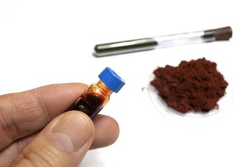 On a white background is shown the reagent for developing fingerprints called sangre de drago in...