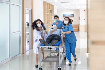 Nurse and doctor in a hurry taking patient to operation theatre. Doctors running for the surgery....
