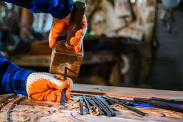 Asian male craftsman carved wood craftsmen use wooden hammers to shovel wood chisels tools...