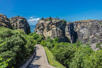 Fototapeta na wymiar Holy Trinity Monastery (Agia Trias) - Eastern Orthodox monastery at the complex of Meteora monasteries. Peneas Valley, Greece. It situated at the top of a rocky precipice over 400 meters high.