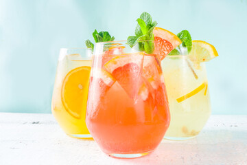 Summer cold drinks, fruit lemonade sangria cocktail, infused beverages with various citrus - orange, lemon, grapefruit, lime, with fresh fruits copy space