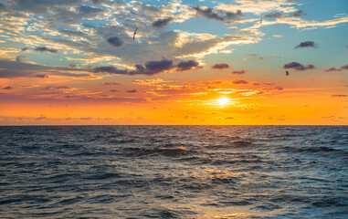 Amazing colorful crimson sunrise in the open sea