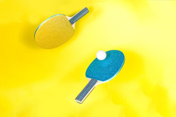 Summer sport activity concept. Bright ping pong tennis paddle  rackets with ball on trendy yellow...