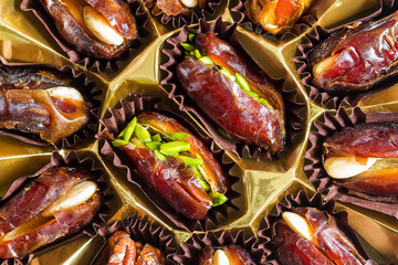 Dried date with pistachios fruits background. Selective focus.