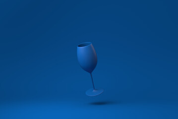 Blue Wine glass floating in blue background. minimal concept idea creative. monochrome. 3D render.