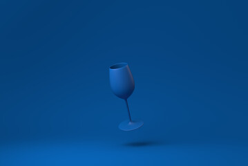 Blue Wine glass floating in blue background. minimal concept idea creative. monochrome. 3D render.