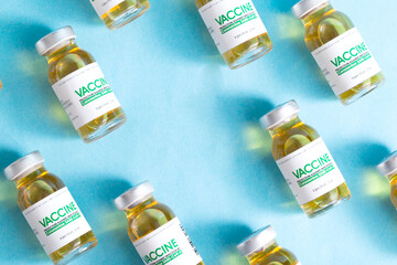 Bottles with doses of the drug for coronavirus on a blue background, copy space for text. SARS-Cov-2