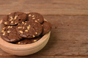 Fototapeta na wymiar Chocolate brownie cookies on wooden plate. Malaysian traditional cookies served during Eid Fitri