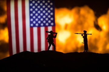 Flag on burning dark background. Concept of crisis of war and political conflicts between nations. Selective focus